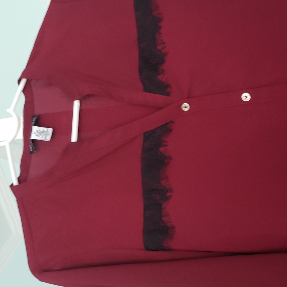 A Karl Lagerfeld button down wine color blouse.